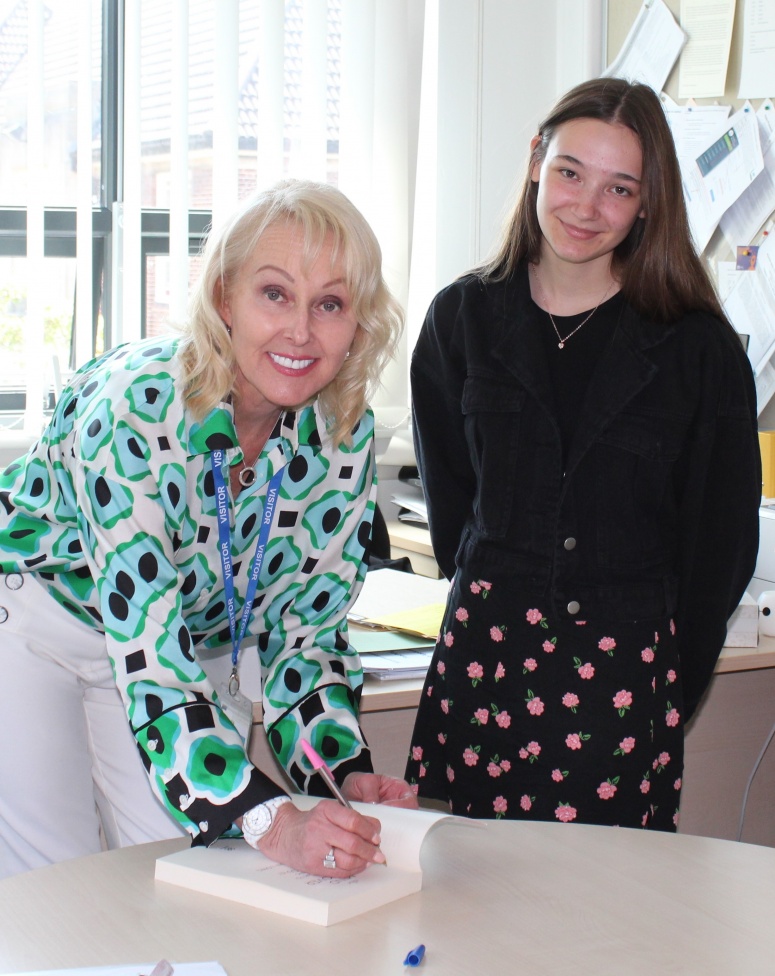 Former High Storrs pupil Sharron Lowe presents current student Emma Ransom with her best-selling self-help book The Mind Makeover, The Answers to The Best YOU Yet! 